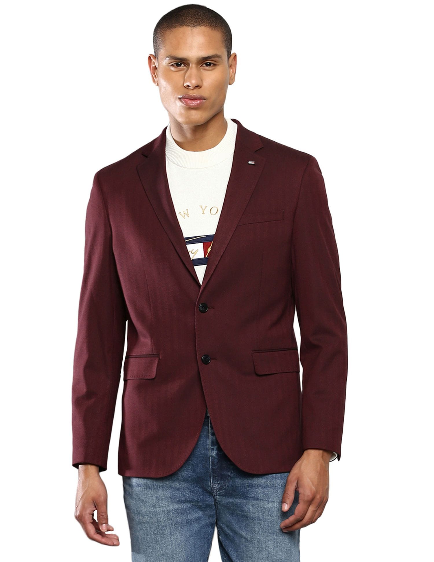 A maroon sport coat paired with dark jeans and a T-shirt