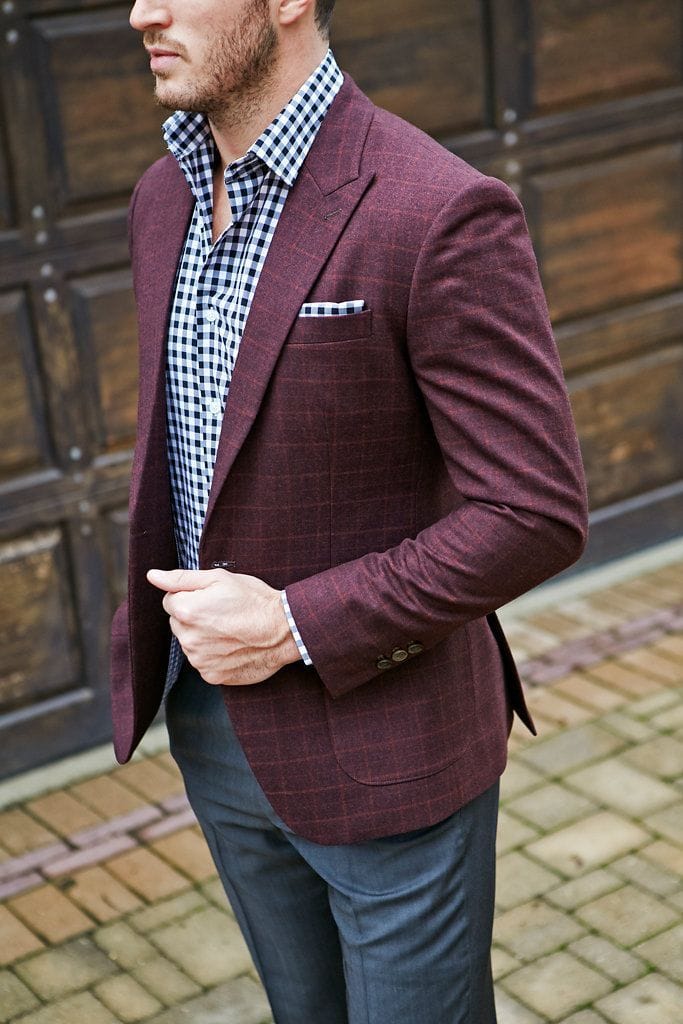 A maroon sport coat paired with a patterned shirt